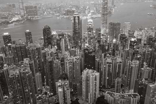 Victoria, Hong Kong - January 8, 2010: view by night from Victoria peak to the skyline and harbor of Hong Kong with spectacular skyscraper scene.