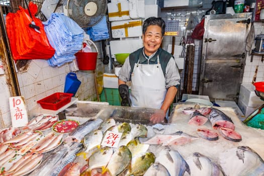 Hongkong, China - January 7, 2010: man selling frsh fish on ice at Fa Yuen street market, the market for fresh food.