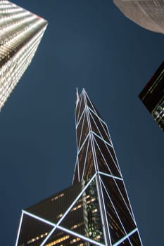 Victoria, Hongkong - January 8, 2010: perspective of skyscraper by night from base level.