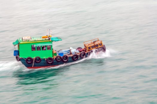 Victoria, Hongkong - January 8, 2010: tug boat cruising Victoria harbor