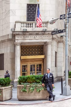 New York, USA - July 9, 2010: small separate entrance to the wall street stock exchange building, protected by a guard in uniform.