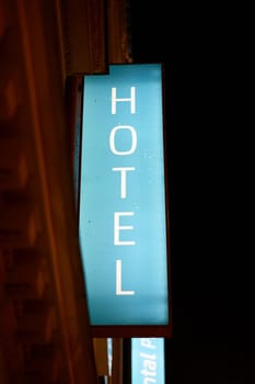 Illuminated sign of a hotel in the city center of Prague in the late evening