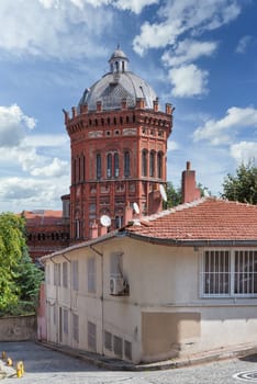 Cobblestone alley in old Balat district, with Phanar Greek Orthodox College, or Ozel Fener Rum Lisesi, Istanbul, Turkey