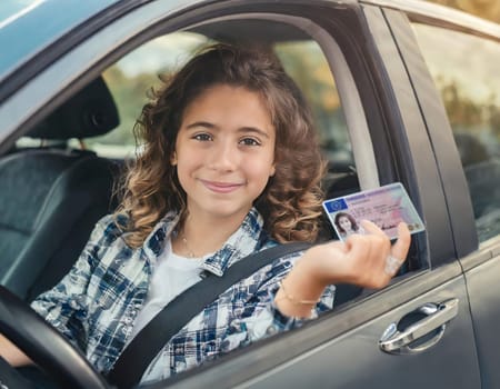 Young woman is happy about the passed driver's license.