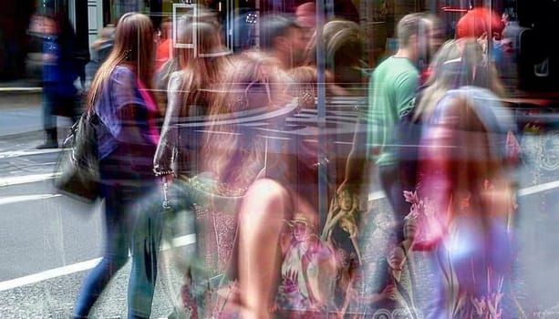Walking people blur. Lots of people walking in the big City. Wide panoramic view of people crossing the road. colorful summer day. Motion blurred background colors