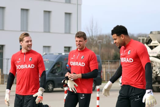 The goalkeepers v.li. Goalkeeper Florian Müller (SC Freiburg),Benjamin Uphoff (SC Freiburg) and goalkeeper Noah Atubolu (SC Freiburg) back on their way to final training ahead of Europa League - Qualification 1/8 Final,SC Freiburg vs RC Lens