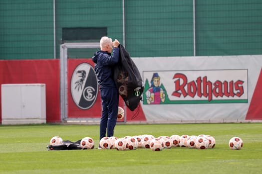 Coach Christian Streich (SC Freiburg) pours out a bag of balls before training at the final training session before the Europa League - Qualification 1/8 Final,SC Freiburg vs RC Lens