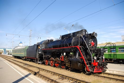 Novosibirsk, Russia - July 20, 2018: Vintage steam locomotive. Open-air museum. locomotive or engine is a rail transport vehicle that provides the motive power for a train.