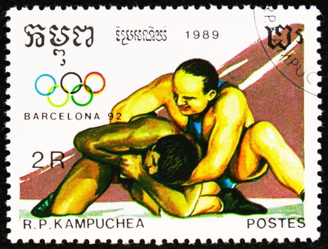 MOSCOW, RUSSIA - OCTOBER 29, 2022: Postage stamp printed in Cambodia shows Wrestling, Summer Olympic Games 1992 - Barcelona (I) serie, circa 1989