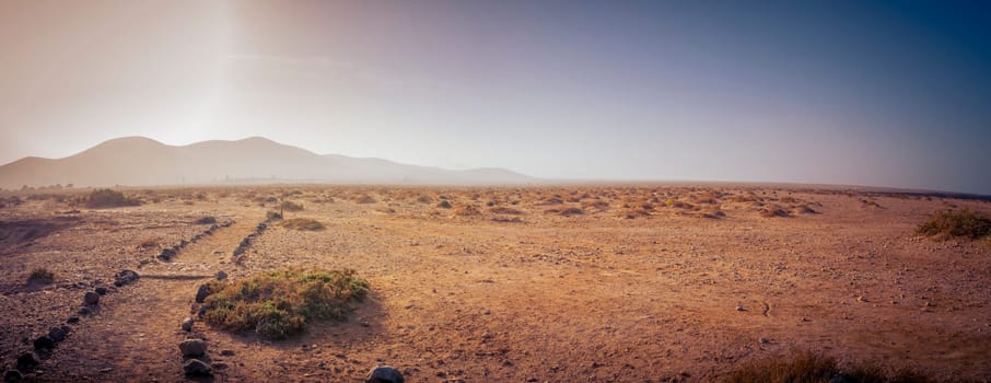 Panorama view on the volcanic desert landscape with hiking trail on Fuerteventura, Canary Islands of Spain.