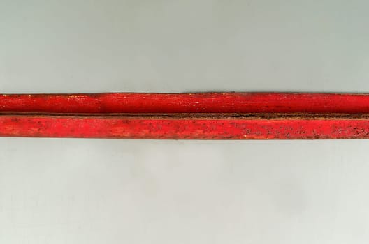 Background texture of a red horizontal rusty metal plate on a light background close-up view from above