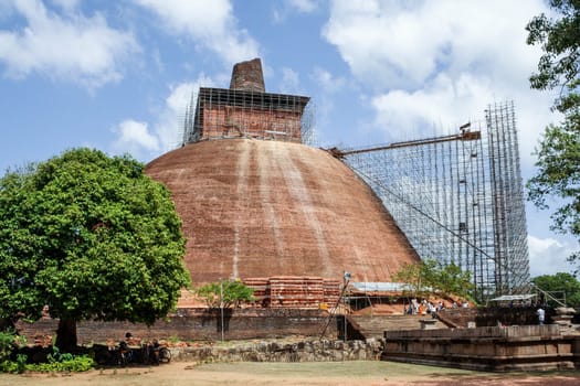 Anuradhapura, Sri Lanka - May 13, 2014: The ruins of the 3rd century Jetavanarama Dagoba at the ancient site of Anuradhapura in Sri Lanka. It was 100 metres tall and constructed using red bricks.
