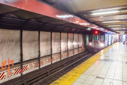 New York, USA - July 11, 2010:  people wait for the arriving train in New York metro.
