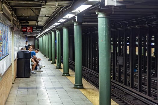 New York, USA - July 11, 2010:  people wait for the arriving train in New York metro.