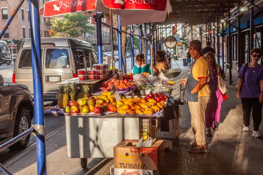 New York, USA - July 11, 2010:  street hawker sells fresh fruits at the street in New York.