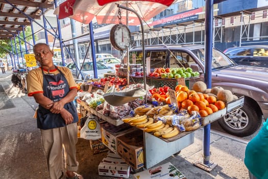 New York, USA - July 11, 2010:  street hawker sells fresh fruits at the street in New York.