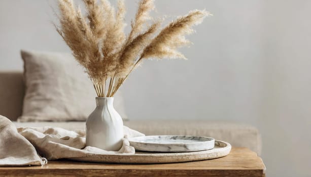 modern white ceramic vase with dry lagurus ovatus grass and marble tray on vintage wooden bench table blurred beige linen blanket in front scandinavian interior empty white wall copy space