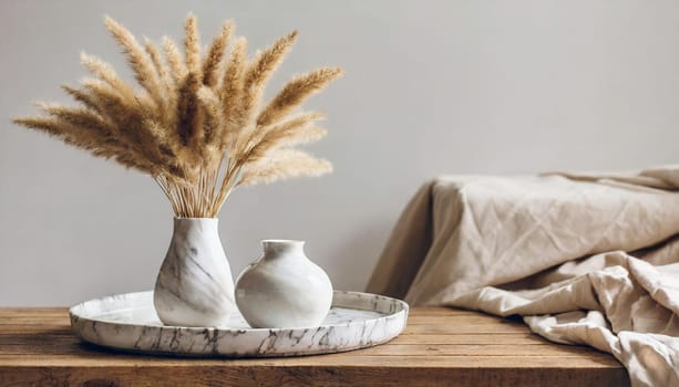 modern white ceramic vase with dry lagurus ovatus grass and marble tray on vintage wooden bench table blurred beige linen blanket in front scandinavian interior empty white wall copy space