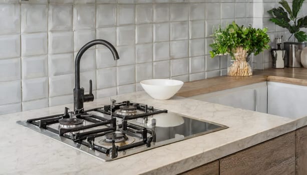 Contemporary kitchen with white countertop, gas stove, and sink.