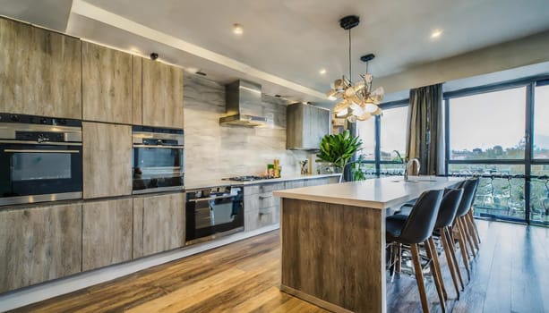 Cozy studio apartment with inviting interior featuring a comfortable brown sofa curtains and a cream colored kitchen with an island