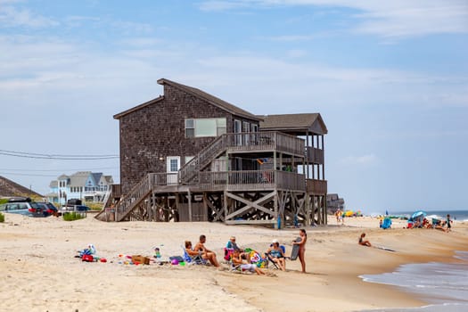 Rodanthe, USA - July 18, 2010: people enjoy the beautiful beach and the wooden Inns at Rodanthe, Hatteras island, USA.