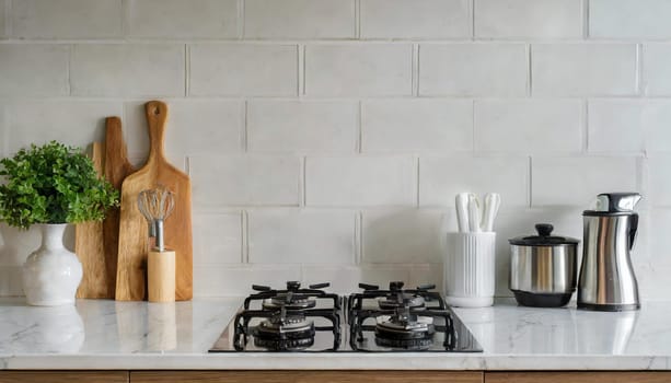 Contemporary kitchen with white countertop, gas stove, and sink.