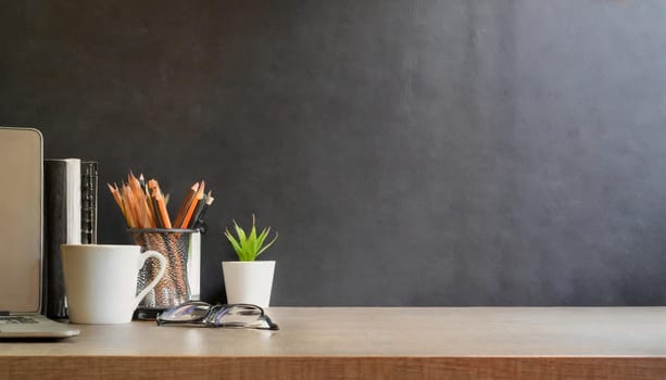 office table with copy space, stationery, vase, and lamp.
