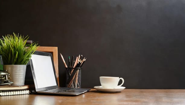 office table with copy space, stationery, vase, and lamp.