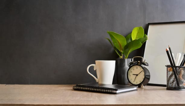 office table with copy space, stationery, vase, and lamp.