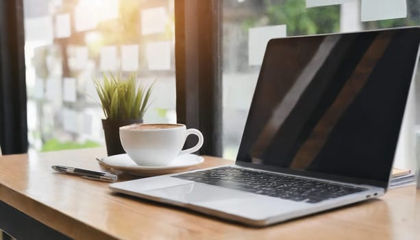 Modern workplace with laptop computer, coffee cup and office supplies