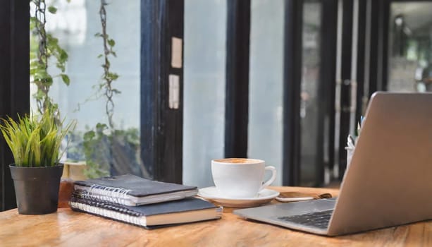 Modern workplace with laptop computer, coffee cup and office supplies