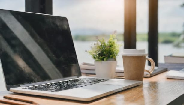 Modern workplace with laptop computer, coffee cup and office supplies