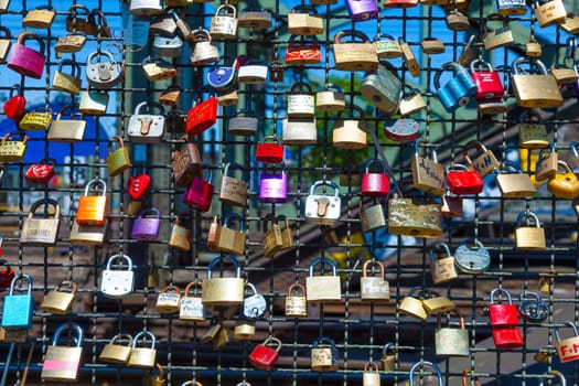 Cologne, Germany - May 29, 2011: lockers at the  Hohenzollern bridge symbolize love for ever in Cologne, Germany. It is the most heavily used railway bridge in Germany and used by pedestrians in love.