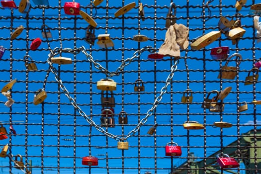 Cologne, Germany - May 29, 2011: lockers at the  Hohenzollern bridge symbolize love for ever in Cologne, Germany. It is the most heavily used railway bridge in Germany and used by pedestrians in love.