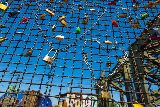 Cologne, Germany - May 29, 2011: lockers at the  Hohenzollern bridge symbolize love for ever in Cologne, Germany. It is the most heavily used railway bridge in Germany and used by pedestrians in love.