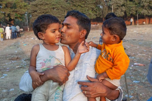 New Delhi, India - November 10, 2011:  proud father poses with his children  Delhi, India. In 1952, India launches  a mass media campaign to spread the concept of family planning to reduce population growth.