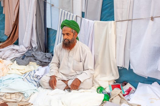 New Delhi, India - November 10, 2011:  portrait of a tailor waiting for customers   at  Meena Bazaar Market in Delhi, India. Shah Jahan founded the bazaar in the 17th century.