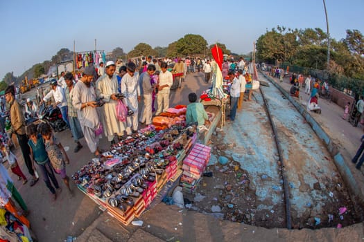 New Delhi, India - November 10, 2011:  people buying shoes at the Meena Bazaar Market  in Delhi, India. Shah Jahan founded the bazaar in the 17th century inspired by the Isfahan Bazaar.