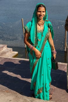 JAIPUR, INDIA - November 12, 2011: attractive indian woman in local sari, dressed for a festival enjoys posing for the photographer.
