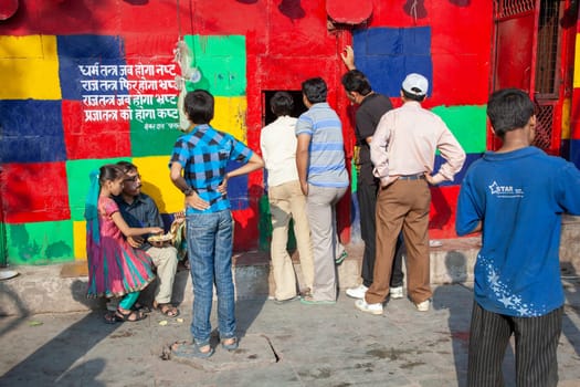 New Delhi, India - November 11, 2011:  wall with political message at Chandini Chowk market. the message means:  when religion gets infected the political class will get corrupt and the citizen will suffer.