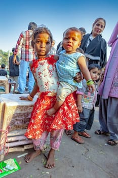 New Delhi, India - November 10, 2011:  portrait of young woman with child on arm  at  Meena Bazaar Market in Delhi, India. Shah Jahan founded the bazaar in the 17th century.