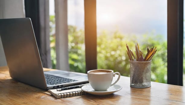 Modern workplace with laptop computer, coffee cup and office supplies