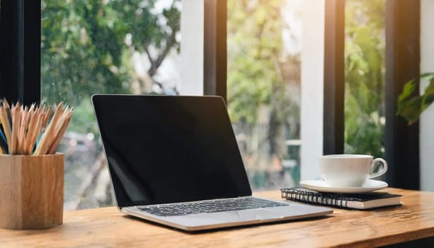 Modern workplace with laptop computer, coffee cup and office supplies