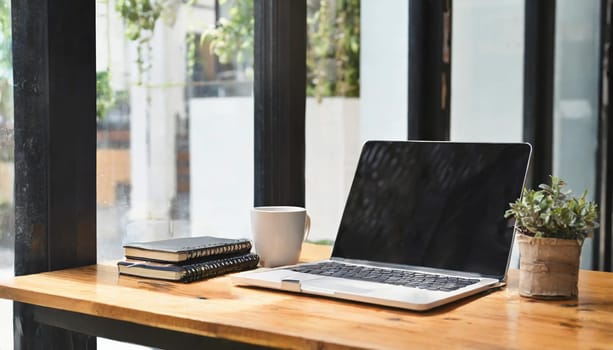 Modern workplace with laptop computer, coffee cup and office supplies