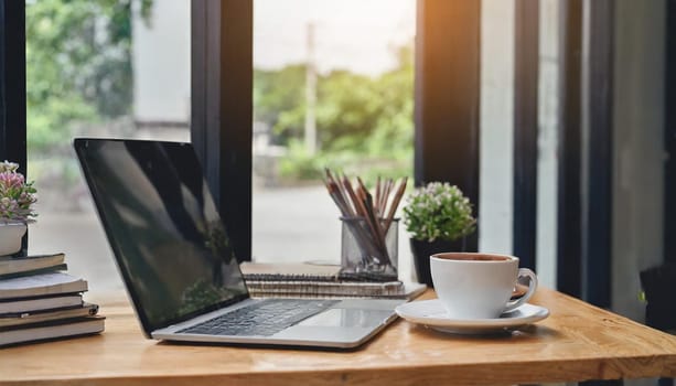 Modern workplace with laptop computer, coffee cup and office supplies