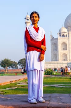 Agra, India - November 16, 2011: local tourists pose for a photo at the Taj Mahal in Agra, India. 2,5 Mio. local tourists visit the UNESCO World heritage site yearly.