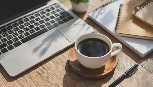 Wood office desk table with a lot of things tablet, laptop ,smartphone ,notepad and coffee cup notepad .copy space virtual interface icons screen.