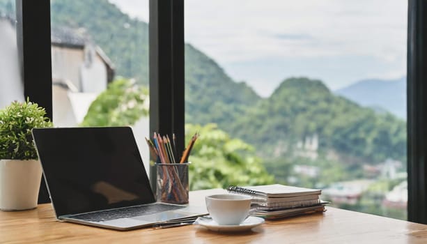 Wood office desk table with a lot of things tablet, laptop ,smartphone ,notepad and coffee cup notepad .copy space virtual interface icons screen.
