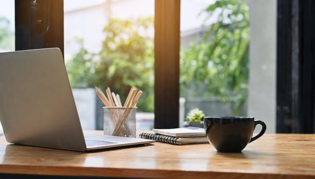 Wood office desk table with a lot of things tablet, laptop ,smartphone ,notepad and coffee cup notepad .copy space virtual interface icons screen.