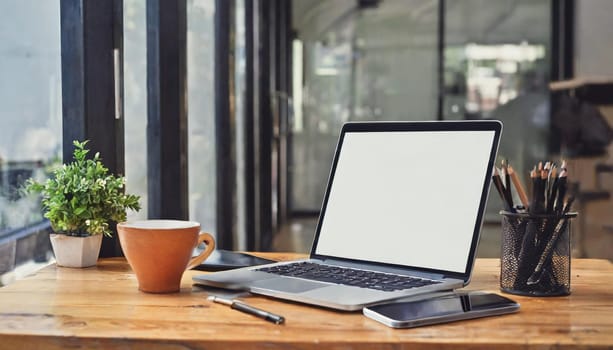 Wood office desk table with a lot of things tablet, laptop ,smartphone ,notepad and coffee cup notepad .copy space virtual interface icons screen.
